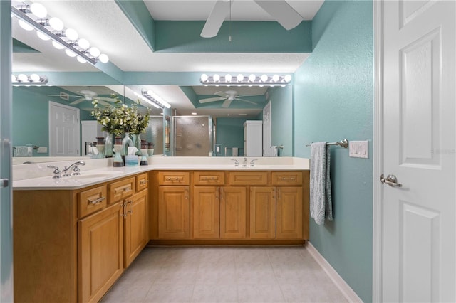 bathroom with an enclosed shower, vanity, and ceiling fan