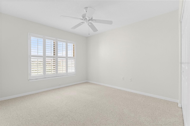 carpeted empty room featuring ceiling fan