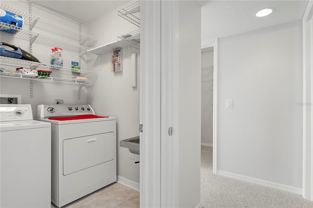 clothes washing area featuring washer and clothes dryer