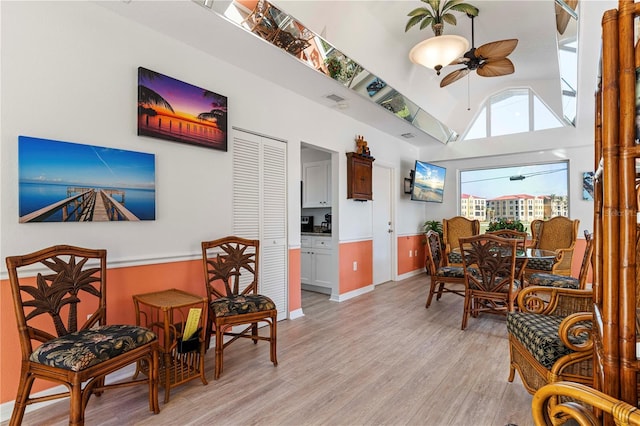 interior space with ceiling fan, light hardwood / wood-style flooring, and lofted ceiling