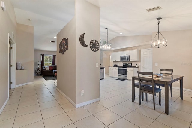 tiled dining area featuring vaulted ceiling and a notable chandelier