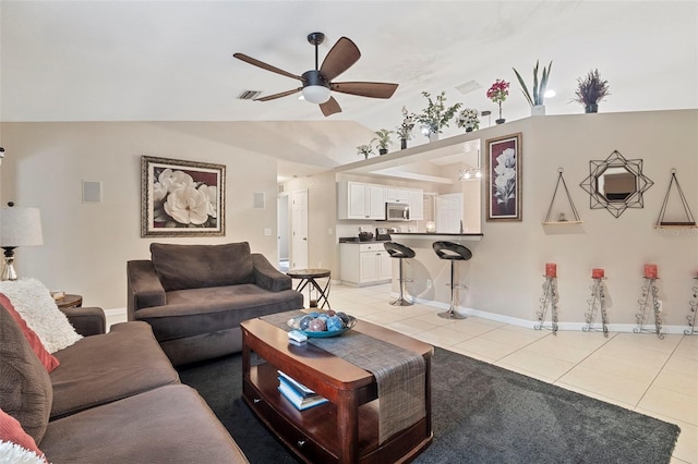 tiled living room with lofted ceiling and ceiling fan