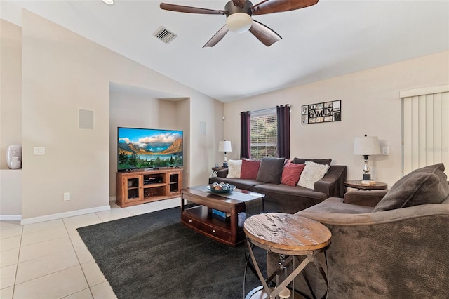 living room featuring ceiling fan, lofted ceiling, and light tile patterned floors