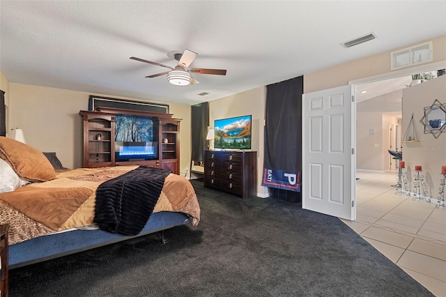 bedroom with ceiling fan and tile patterned flooring