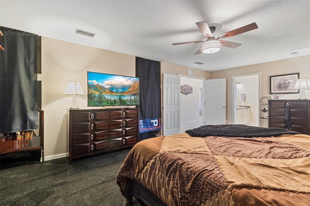 carpeted bedroom featuring ensuite bathroom, a textured ceiling, and ceiling fan