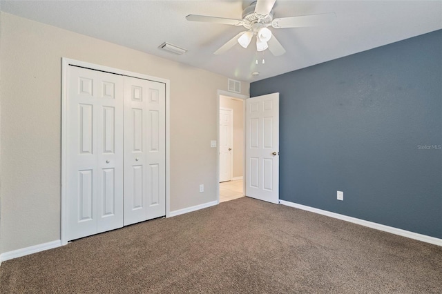 unfurnished bedroom with a closet, ceiling fan, and carpet floors