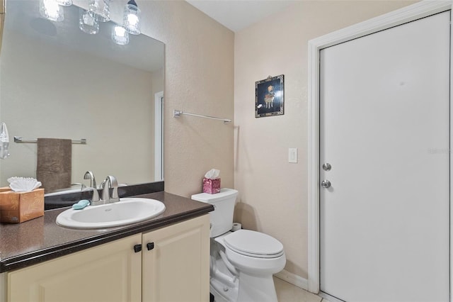 bathroom featuring toilet, tile patterned floors, and vanity