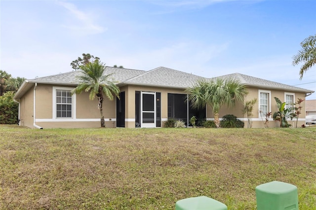 rear view of property with a yard