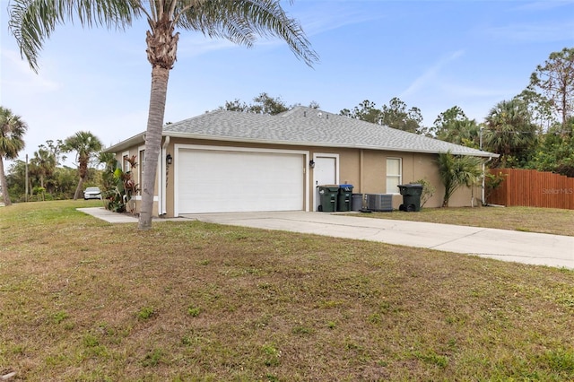 view of side of property featuring central air condition unit, a lawn, and a garage