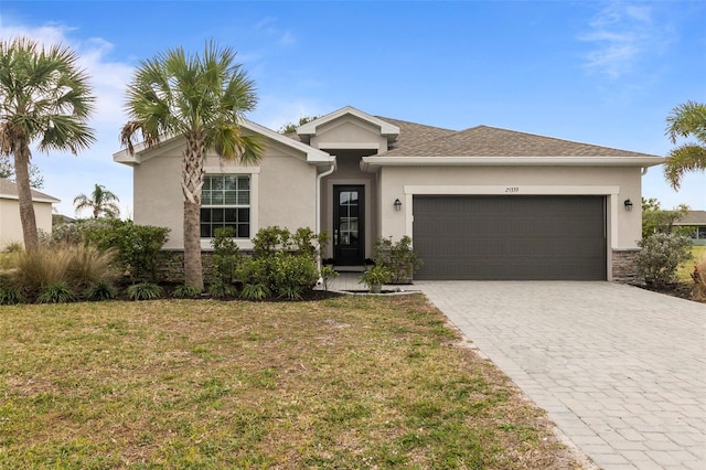 view of front of home with a front lawn and a garage