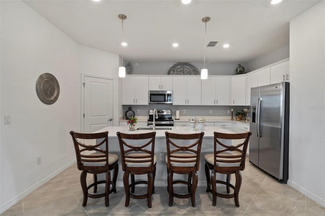 kitchen with white cabinets, pendant lighting, and appliances with stainless steel finishes