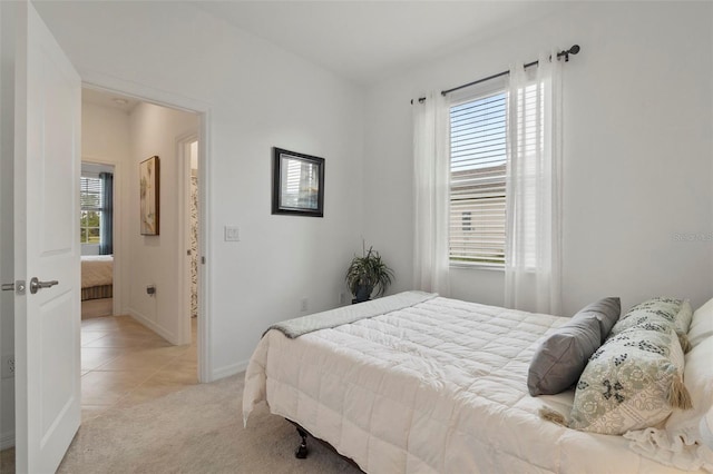 bedroom featuring light colored carpet