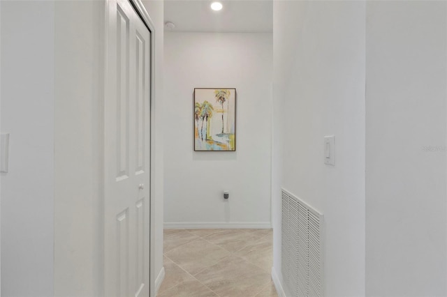 hall with light tile patterned floors