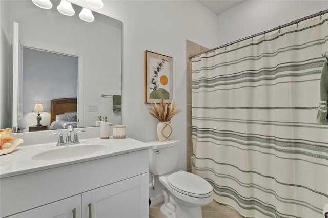 bathroom featuring toilet, a shower with curtain, tile patterned floors, and vanity