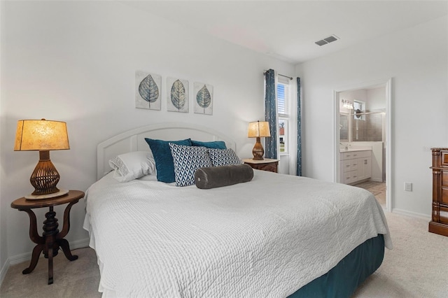 carpeted bedroom featuring connected bathroom