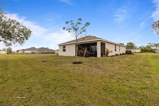 back of house with a lawn