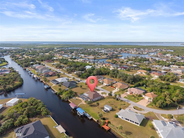 drone / aerial view with a water view and a residential view