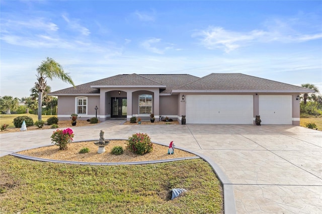 view of front facade with a garage, concrete driveway, a shingled roof, and stucco siding