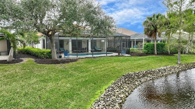 back of house with a lanai and a lawn