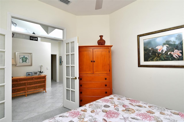 tiled bedroom featuring ceiling fan