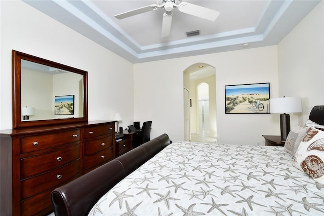 bedroom featuring ceiling fan and a tray ceiling