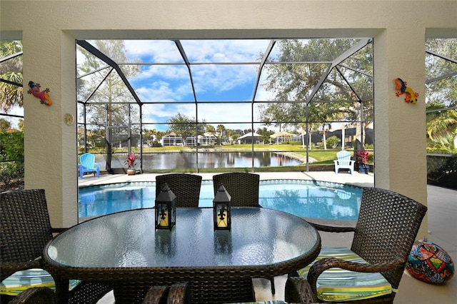 view of pool featuring a lanai, a patio area, and a water view