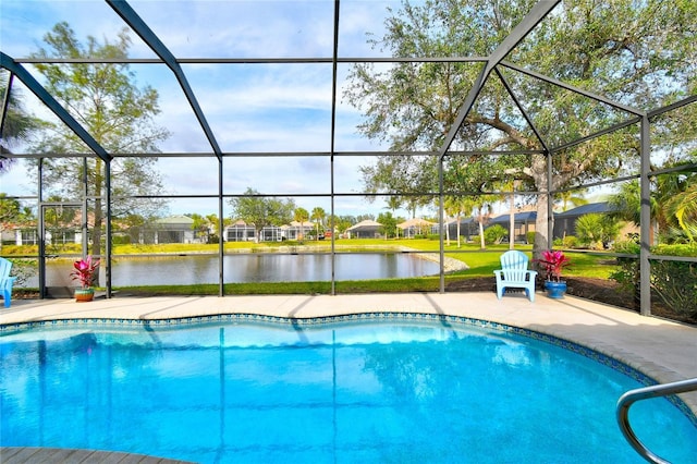 view of pool featuring a patio area, glass enclosure, and a water view