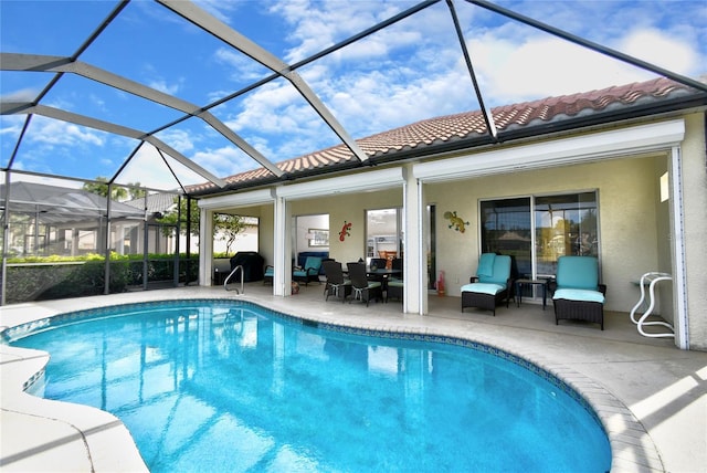 view of swimming pool featuring a patio area and glass enclosure