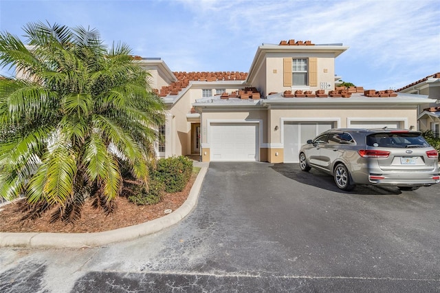 mediterranean / spanish house with a garage