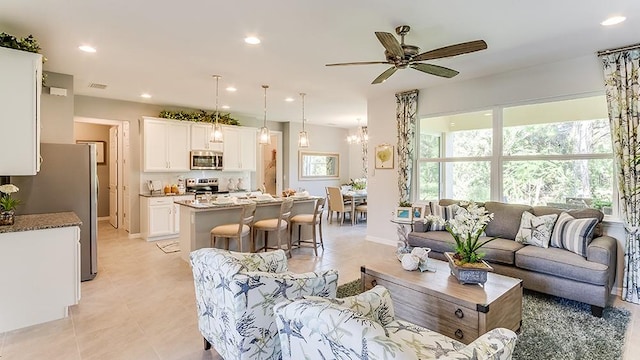 living room featuring light tile patterned flooring and ceiling fan