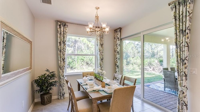 dining space featuring an inviting chandelier and light tile patterned floors