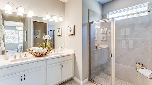 bathroom featuring a shower with door, a wealth of natural light, and vanity