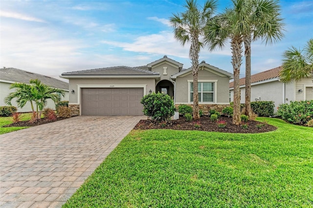 single story home with a garage and a front lawn