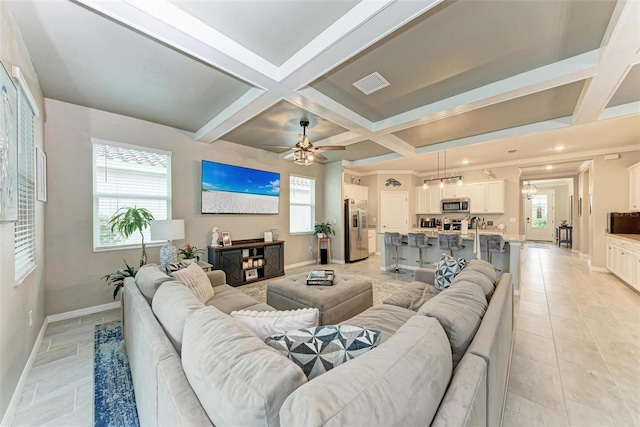 tiled living room featuring coffered ceiling, beamed ceiling, ceiling fan, and a fireplace