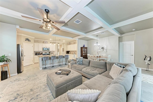 tiled living room featuring coffered ceiling, ceiling fan with notable chandelier, and beam ceiling