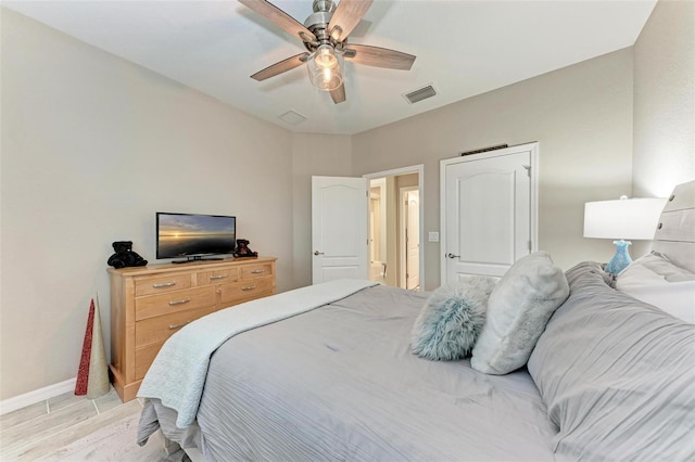 bedroom with ceiling fan and light hardwood / wood-style flooring