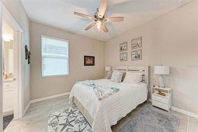 bedroom with ceiling fan and connected bathroom