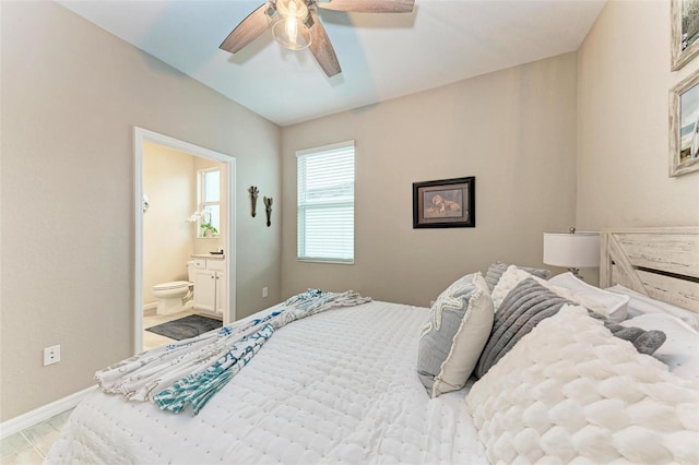 bedroom with ceiling fan, connected bathroom, and light hardwood / wood-style floors