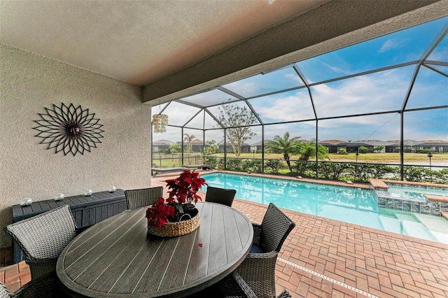 view of swimming pool featuring an in ground hot tub, a lanai, and a patio