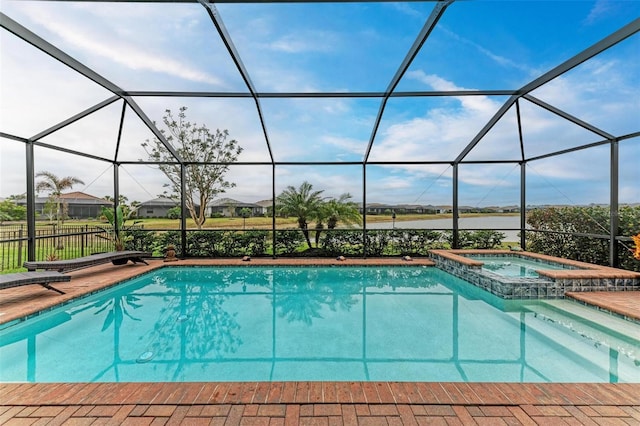 view of swimming pool with an in ground hot tub, a lanai, and a patio area