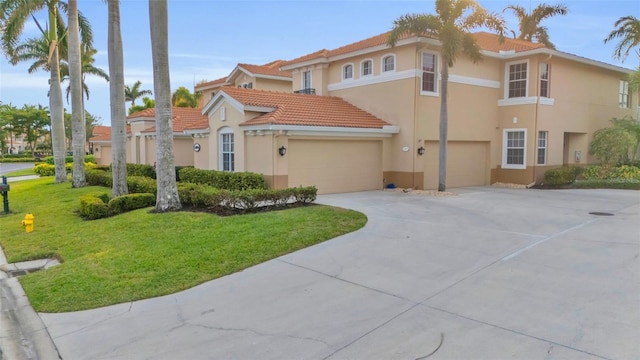 mediterranean / spanish house with a garage and a front yard