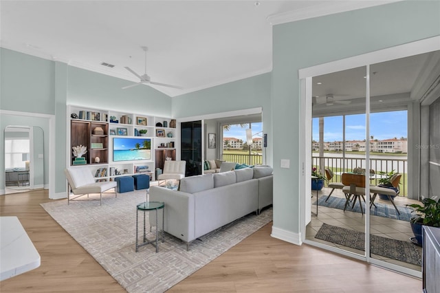 living room with a healthy amount of sunlight, light hardwood / wood-style flooring, and ceiling fan