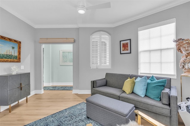 living room featuring ceiling fan, ornamental molding, and light hardwood / wood-style floors