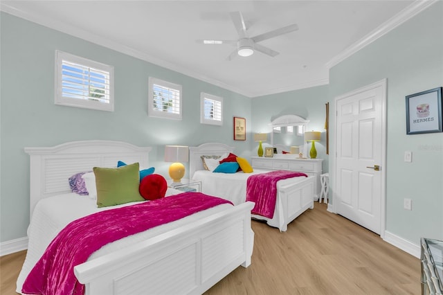 bedroom with multiple windows, ornamental molding, and light hardwood / wood-style floors