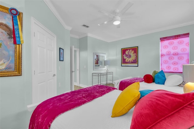 bedroom with ornamental molding and ceiling fan