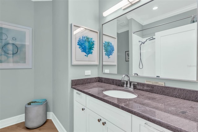 bathroom featuring walk in shower, vanity, and wood-type flooring