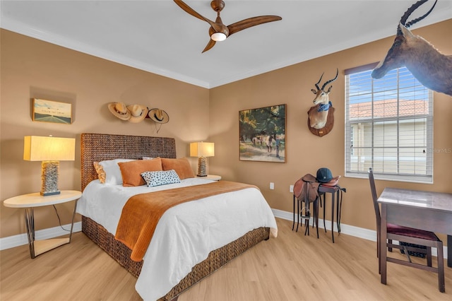 bedroom featuring crown molding, hardwood / wood-style flooring, and ceiling fan