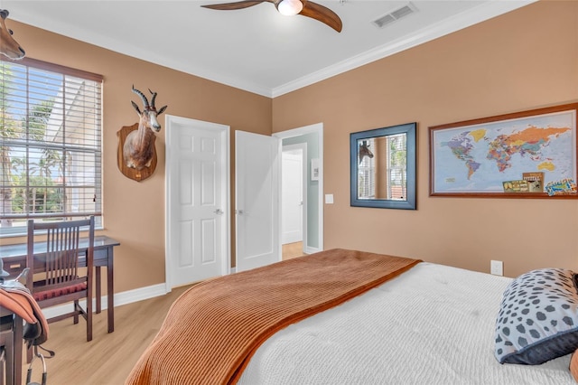 bedroom with ornamental molding and light wood-type flooring