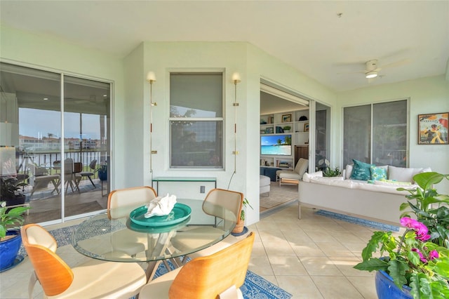 sunroom / solarium featuring ceiling fan