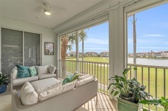 sunroom / solarium featuring a water view